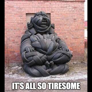 A buddha figure made out of car tyres. Caption: 'It is all so tiresome'