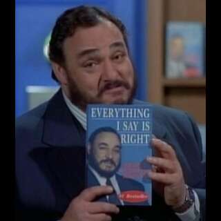Dom DeLuise holding a book, that has a picture of him on the cover, titled 'Everything I say is right'.