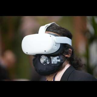 A man wearing a VR helmet and a face mask.
